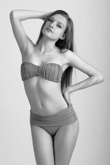 Slim body of young woman in bikini on white . Girl with healthy sporty figure