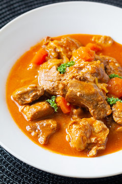 Food concept french classic veal stew marengo de veau in white ceramic plate with copy space