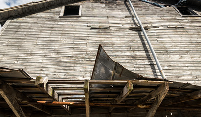 Abandoned building with rusted and torn metal roofing