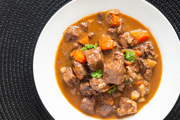 Food concept french classic beefs stew estouffade de boeuf in white ceramic plate with copy space