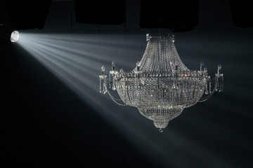 Beautiful crystal chandelier in the rays of light