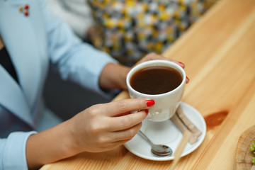 top view woman in blue jacket hold cup of coffee