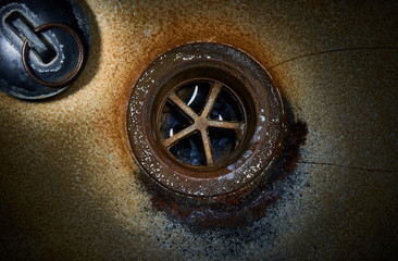 Drain hole with plug in old sink.Close up.