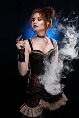 A beautiful redhead cosplayer girl wearing a Victorian-style steampunk costume with a big breast in a deep cleavage standing thoughtfully in a puff of smoke on a black background