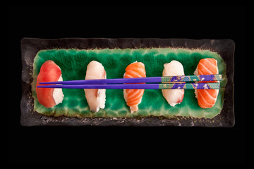 Top view of a sushis plate isolated on black background
