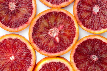 Bloody orange on a white background. Red orange cut into slices on a white background.