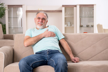 White bearded old man suffering at home 