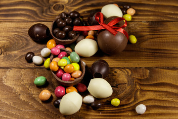 Easter composition with chocolate eggs on wooden background