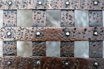 St. Petersburg, Russia, March 10, 2019. Fragment of a bronze lattice with rivets as the basis of the background.