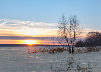 Beautiful sunset on the greate Volga river. Lot of ice on the  winter river