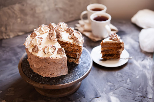 Homemade Kiev cake, dacquoise cake with butter cream and hazelnuts. Gradient  layers in brown shades