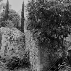 Fototapeta premium Girona, Spain, August 2018. The fortress wall and the tower of the Catholic Cathedral against the background of the forthcoming th
