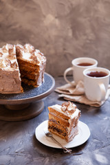 Homemade Kiev cake, dacquoise cake with butter cream and hazelnuts. Gradient  layers in brown shades