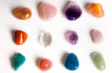 Healing stones various minerals over white bakgriund like reiki, wellness concept 