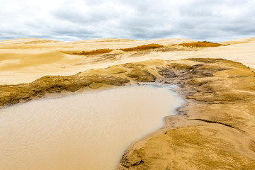 Sand Sculpture and water pond at Giant sand dunes, Te Paki, Northland, North Island, New Zealand