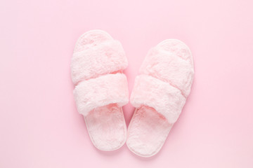 Composition of faux fur slippers on a light pink background. Morning concept. Flat Lay. Top View