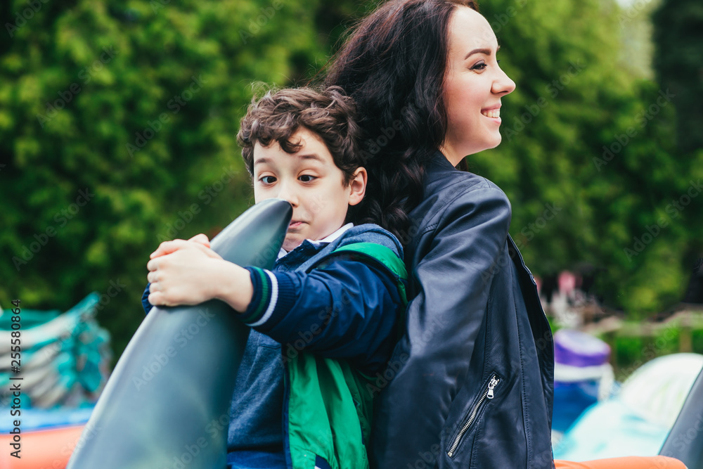 Wall mural Son and mother in the amusement park.