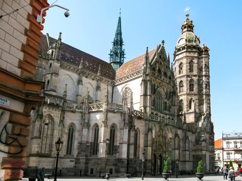 Kosice, Slovakia - May 2, 2018: Beautiful Gothic Cathedral of St. Elizabeth in Kosice. Ancient stone temple with a brown roof, a clock tower and stucco on the walls on a sunny spring-summer day