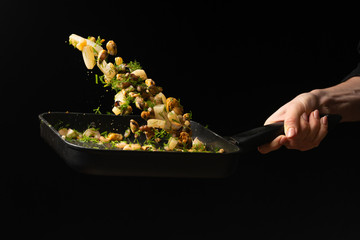 Professional chef prepares seafood with greens. octopus kalmar mussels. Sea food. Asian and Eastern cuisine. culinary background. Food freeze. Close-up menu © Anton