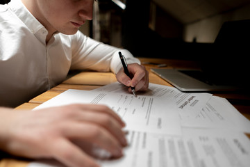close up office worker hold pen and sign documents or a contract