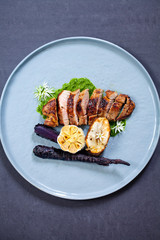 Lamb leg fillet with wild garlic puree, roast garlic bulb and jerusalem artichoke