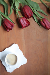  Morning composition.  Cup of coffee, fresh flowers on wooden background. Flat lay, top view, copy space