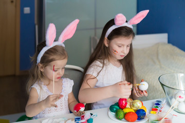  Girls paint easter eggs