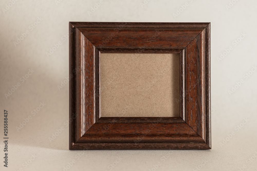 Wall mural empty brown rustic photo frame on simple background