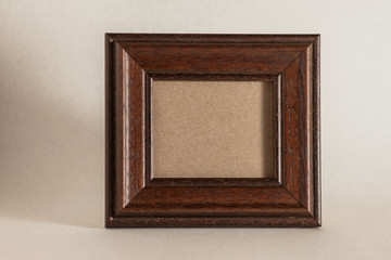 empty brown rustic photo frame on simple background