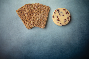 Cheese and crackers on blue background 