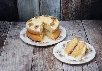 Walnut sponge cake on wooden background 