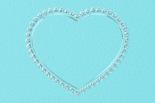 Heart-shaped frame made of small diamonds and glossy silver on turquoise textured background