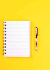 Notebook, and pen on a bright yellow background.Accessories office concept.Business Idea. Time to school.Top View.Flat Lay. Copy space for Text.