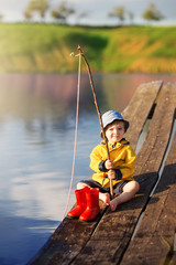 Boy on wooden dock with a fishing net