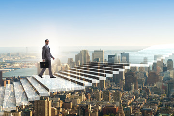 Businessman climbing career ladder over city