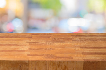 Empty wooden table over abstract bokeh background.