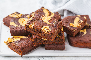 Vegan brownie with peanut butter on white background.