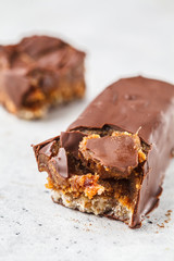 Vegan cocoa dates chocolate raw bars on white background.