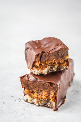 Vegan cocoa dates chocolate raw bars on white background.