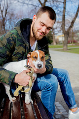 Young man with his dog, Jack Russell Terrier,