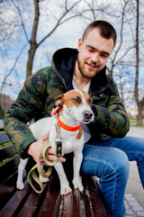 Young man with his dog, Jack Russell Terrier,
