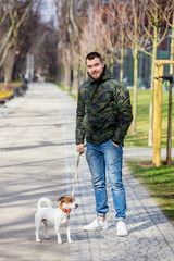 Young man with his dog, Jack Russell Terrier