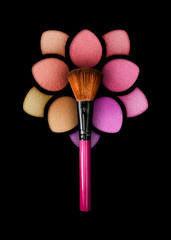 Professional make-up brush on a beautiful multicolored eyeshadow palette