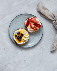 Fruit sandwiches with vegan ricotta cheese on marble background. view from above with copy space