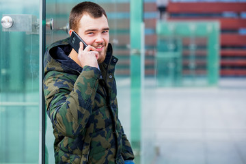 Young man speaking with mobile phone