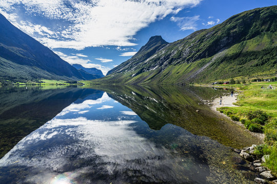Scenic Eidsvatnet lake near Geirangerfjord with sky mirrored in the water, Sunnmore, More og Romsdal, Norway