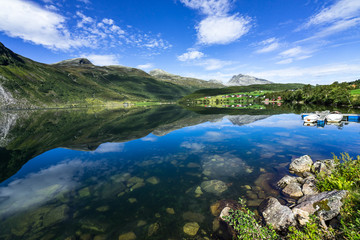Naklejka na ściany i meble The amazing landscape of Eidsvatnet lake reflected in the water. Eidsvatnet lake is located between Geirangerfjord and Eidsdal, Sunnmore, More og Romsdal, Norway