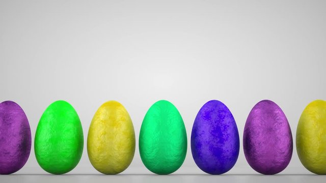 Chocolate easter eggs wrapped in colorful aluminum foil on white background. Delicious chocolate easter eggs in holiday easter day concept