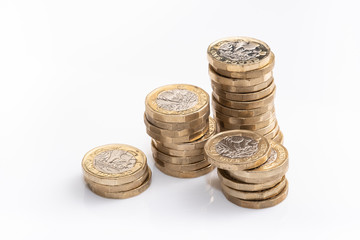 UK money, pound coins in small piles