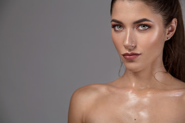 Closeup portrait of beautiful young woman with clean and fresh skin. Nude makeup. Concept for cosmetology ads with copy space, beauty magazine and spa.